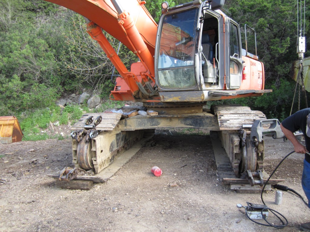 track pin press being used to repair track on excavator