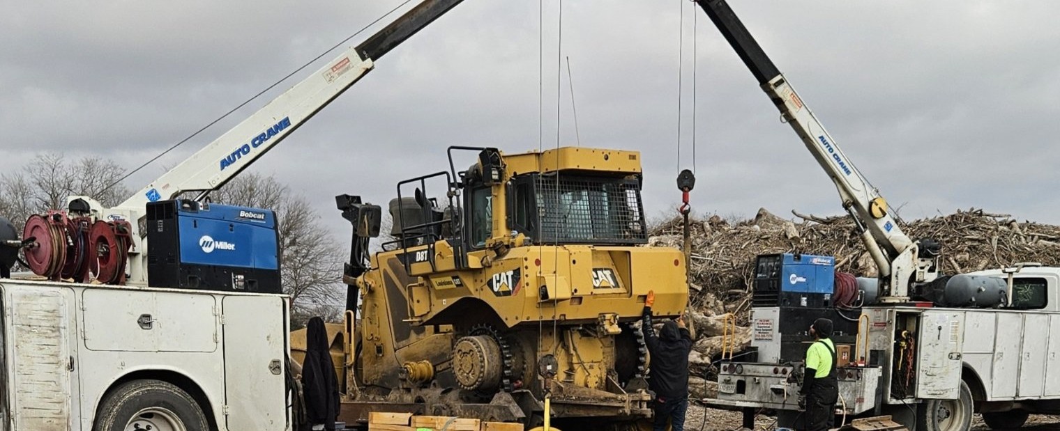 Two A.L. Boeck and Co. service trucks with auto cranes working CAT D8T dozer on job site San Antonio Texas heavy equipment repair